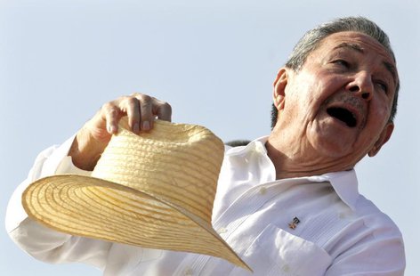 Cuba's President Raul Castro puts his hat on after waving to the crowd at the annual May Day parade at Havana's Revolution Square May 1, 201 Cuba's President Raul Castro puts his hat on after waving to the crowd at the annual May Day parade at Havana's Revolution Square May 1, 201
