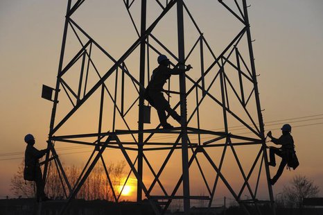 Employees check on an electricity pylon in Chuzhou, Anhui province, May 1, 2013. REUTERS/China Daily Employees check on an electricity pylon in Chuzhou, Anhui province, May 1, 2013. REUTERS/China Daily
