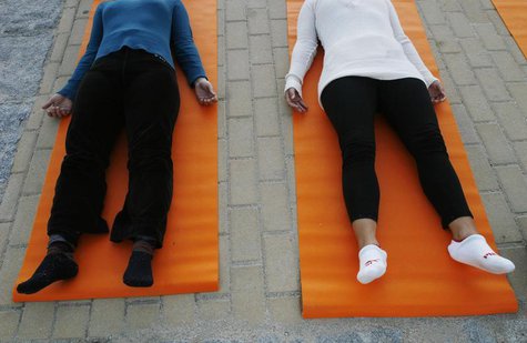 People take part in a free yoga class at the Parque del Oeste in Madrid September 27, 2007. REUTERS/Susana Vera People take part in a free yoga class at the Parque del Oeste in Madrid September 27, 2007. REUTERS/Susana Vera
