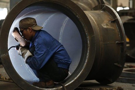 An employee welds a water turbine at a factory in Jinhua, Zhejiang province May 23, 2013. REUTERS/William Hong An employee welds a water turbine at a factory in Jinhua, Zhejiang province May 23, 2013. REUTERS/William Hong