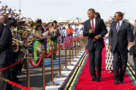 U.S. President Barack Obama dances as a Tanzanian band plays during an official arrival ceremony at Julius Nyerere Airport in Dar es Salaam, U.S. President Barack Obama dances as a Tanzanian band plays during an official arrival ceremony at Julius Nyerere Airport in Dar es Salaam,