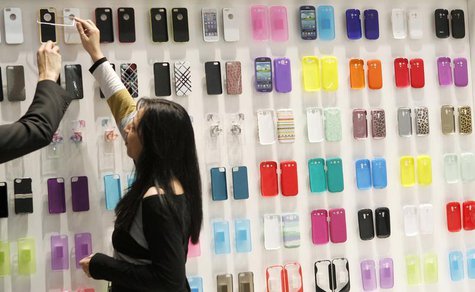 A visitor looks at mobile phone covers at the Mobile World Congress in Barcelona February 28, 2013. REUTERS/Albert Gea A visitor looks at mobile phone covers at the Mobile World Congress in Barcelona February 28, 2013. REUTERS/Albert Gea