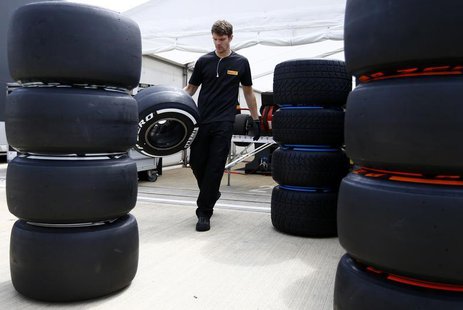 A Pirelli technician carries a tyre ahead of the British Grand Prix at the Silverstone Race circuit, central England, June 27, 2013. REUTERS A Pirelli technician carries a tyre ahead of the British Grand Prix at the Silverstone Race circuit, central England, June 27, 2013. REUTERS