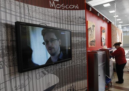 A television screens the image of former U.S. spy agency contractor Edward Snowden during a news bulletin at a cafe at Moscow's Sheremetyevo A television screens the image of former U.S. spy agency contractor Edward Snowden during a news bulletin at a cafe at Moscow's Sheremetyevo