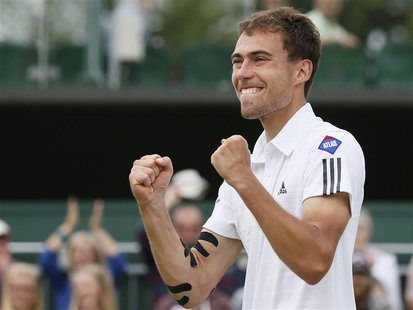 Jerzy Janowicz of Poland celebrates after defeating Jurgen Melzer of Austria in their men's singles tennis match at the Wimbledon Tennis Cha Jerzy Janowicz of Poland celebrates after defeating Jurgen Melzer of Austria in their men's singles tennis match at the Wimbledon Tennis Cha