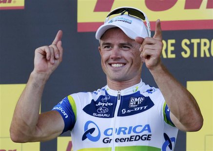 Orica Greenedge team rider Simon Gerrans of Australia celebrates his victory on the podium of the 145,5 km third stage of the centenary Tour Orica Greenedge team rider Simon Gerrans of Australia celebrates his victory on the podium of the 145,5 km third stage of the centenary Tour