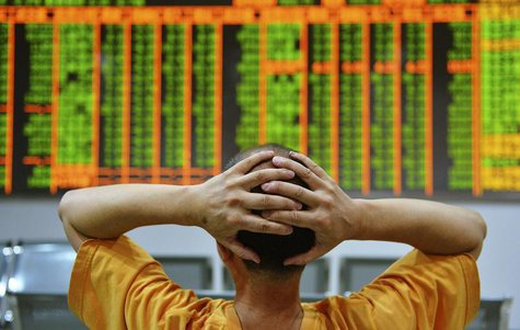 An investor sits in front of an electronic board showing stock information at a brokerage house in Hangzhou, Zhejiang province, June 24, 201 An investor sits in front of an electronic board showing stock information at a brokerage house in Hangzhou, Zhejiang province, June 24, 201