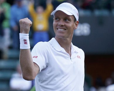 Tomas Berdych of the Czech Republic celebrates after defeating Bernard Tomic of Australia in their men's singles tennis match at the Wimbled Tomas Berdych of the Czech Republic celebrates after defeating Bernard Tomic of Australia in their men's singles tennis match at the Wimbled
