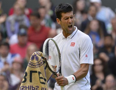 Novak Djokovic of Serbia reacts after winning the second set in his men's singles tennis match against Tommy Haas of Germany at the Wimbledo Novak Djokovic of Serbia reacts after winning the second set in his men's singles tennis match against Tommy Haas of Germany at the Wimbledo