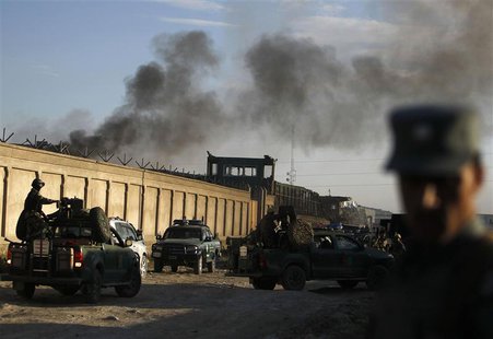 Afghan security forces keep watch as smoke rises from the site of an attack in Kabul, July 2, 2013. REUTERS/Omar Sobhani Afghan security forces keep watch as smoke rises from the site of an attack in Kabul, July 2, 2013. REUTERS/Omar Sobhani