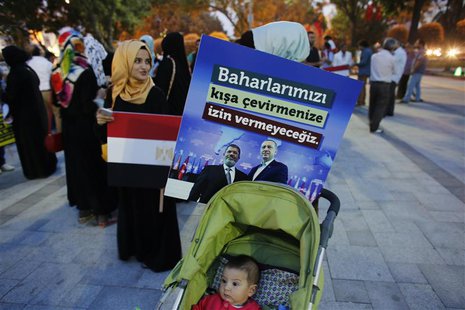 A poster with the pictures of Egypt's President Mohamed Mursi and Turkey's Prime Minister Tayyip Erdogan (R) is attached to a baby stroller A poster with the pictures of Egypt's President Mohamed Mursi and Turkey's Prime Minister Tayyip Erdogan (R) is attached to a baby stroller