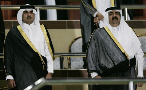 Qatar's Amir Sheikh Hamad bin Khalifa al-Thani (R) and Crown Prince Sheikh Tamim bin Hamad al-Thani arrive at Al-Rayyan Stadium during the f Qatar's Amir Sheikh Hamad bin Khalifa al-Thani (R) and Crown Prince Sheikh Tamim bin Hamad al-Thani arrive at Al-Rayyan Stadium during the f