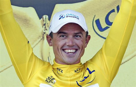 Orica Greenedge team rider Simon Gerrans of Australia celebrates his yellow jersey win on the podium of the 25km team time-trial fourth stag Orica Greenedge team rider Simon Gerrans of Australia celebrates his yellow jersey win on the podium of the 25km team time-trial fourth stag