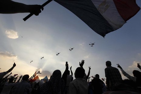 Military helicopters fly above Tahrir Square while protesters opposing Egyptian President Mohamed Mursi shout slogans against him and Brothe Military helicopters fly above Tahrir Square while protesters opposing Egyptian President Mohamed Mursi shout slogans against him and Brothe