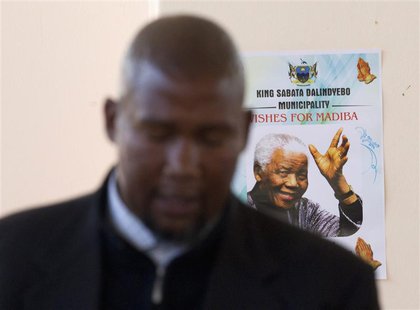 Mandla Mandela, grandson of former South African President Nelson Mandela, sings in front of a poster of his grandfather during a church ser Mandla Mandela, grandson of former South African President Nelson Mandela, sings in front of a poster of his grandfather during a church ser