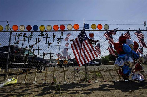 American flags, crosses and balloons are displayed at a makeshift memorial for the 19 firefighters who perished battling a fast-moving wildl American flags, crosses and balloons are displayed at a makeshift memorial for the 19 firefighters who perished battling a fast-moving wildl