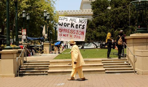 Walter Davis walks past a sign on Frank Ogawa Plaza as striking Oakland city workers and 2,400 employees of the Bay Area Rapid Transit (BART Walter Davis walks past a sign on Frank Ogawa Plaza as striking Oakland city workers and 2,400 employees of the Bay Area Rapid Transit (BART