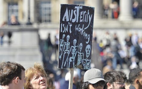 A protester holds a placard during a rally in Trafalgar Square in central London May 1, 2013. REUTERS/Toby Melville A protester holds a placard during a rally in Trafalgar Square in central London May 1, 2013. REUTERS/Toby Melville