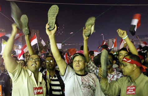Anti-President Mohamed Mursi protesters hold up their shoes after a speech by Mursi, at Tahrir Square in Cairo July 3, 2013. REUTERS/Mohamed Anti-President Mohamed Mursi protesters hold up their shoes after a speech by Mursi, at Tahrir Square in Cairo July 3, 2013. REUTERS/Mohamed