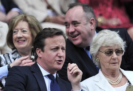 Britain's Prime Minister David Cameron (L) sits on Centre Court for the men's singles final tennis match between Roger Federer of Switzerlan Britain's Prime Minister David Cameron (L) sits on Centre Court for the men's singles final tennis match between Roger Federer of Switzerlan