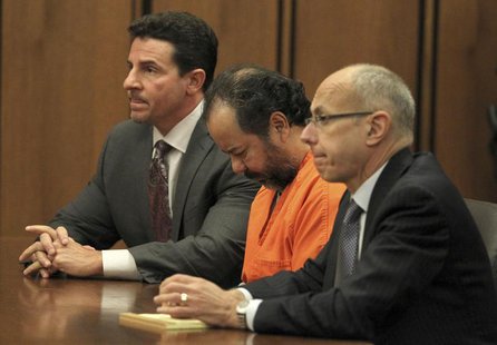 Ariel Castro, 52, sits with his head down between his attorneys Jaye Schlachet (R) and Craig Weintraub (L) during his pre-trial hearing on c Ariel Castro, 52, sits with his head down between his attorneys Jaye Schlachet (R) and Craig Weintraub (L) during his pre-trial hearing on c