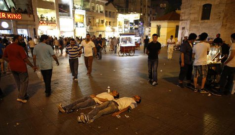 Two protesters lie on the ground of Taksim Square as they stage a silent protest in Istanbul June 29, 2013. REUTERS/Umit Bektas Two protesters lie on the ground of Taksim Square as they stage a silent protest in Istanbul June 29, 2013. REUTERS/Umit Bektas