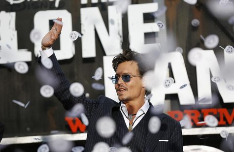 Cast member Johnny Depp waves as confetti fly at the world premiere of "The Lone Ranger" at Disney California Adventure Park in Anaheim, Cal Cast member Johnny Depp waves as confetti fly at the world premiere of "The Lone Ranger" at Disney California Adventure Park in Anaheim, Cal
