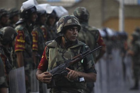 Army soldiers take their positions in front of protesters who are against Egyptian President Mohamed Mursi, near the Republican Guard headqu Army soldiers take their positions in front of protesters who are against Egyptian President Mohamed Mursi, near the Republican Guard headqu