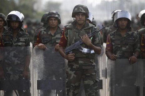 Army soldiers take their positions in front of protesters who are against Egyptian President Mohamed Mursi, near the Republican Guard headqu Army soldiers take their positions in front of protesters who are against Egyptian President Mohamed Mursi, near the Republican Guard headqu