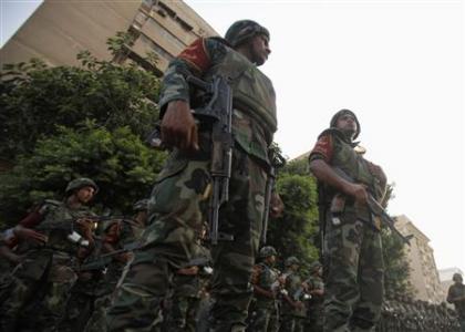 Army soldiers stand guard in front of protesters who are against Egyptian President Mohamed Mursi, near the presidential palace in Cairo July 3, 2013.
Credit: REUTERS/Amr Abdallah Dalsh Army soldiers stand guard in front of protesters who are against Egyptian President Mohamed Mursi, near the presidential palace in Cairo July 3, 2013.
Credit: REUTERS/Amr Abdallah Dalsh