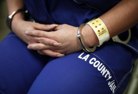 A woman sits handcuffed after arriving at the Los Angeles County women's jail in Lynwood, California April 26, 2013. REUTERS/Lucy Nicholson A woman sits handcuffed after arriving at the Los Angeles County women's jail in Lynwood, California April 26, 2013. REUTERS/Lucy Nicholson