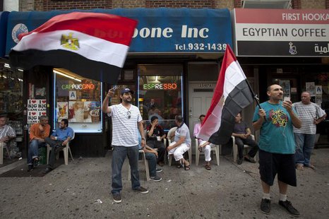 Men wave Egyptian flags on the street in the Queens borough of New York, July 3, 2013. REUTERS/Carlo Allegri Men wave Egyptian flags on the street in the Queens borough of New York, July 3, 2013. REUTERS/Carlo Allegri