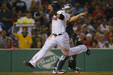 Boston Red Sox's Jonny Gomes (front) crosses home plate for a run in front of San Diego Padres catcher Nick Hundley during the sixth inning Boston Red Sox's Jonny Gomes (front) crosses home plate for a run in front of San Diego Padres catcher Nick Hundley during the sixth inning