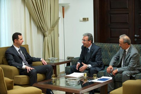 Syria's President Bashar al-Assad (L) is seen during an interview with the al-Thawra newspaper in Damascus in this handout photograph distri Syria's President Bashar al-Assad (L) is seen during an interview with the al-Thawra newspaper in Damascus in this handout photograph distri