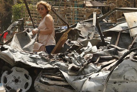 A women inspects her neighbourhood, which is near the Bilal bin Rabah mosque complex where hardline Sunni cleric Sheikh Ahmed al-Assir was b A women inspects her neighbourhood, which is near the Bilal bin Rabah mosque complex where hardline Sunni cleric Sheikh Ahmed al-Assir was b