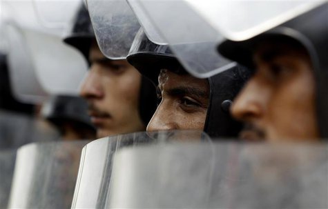 Riot police stand with their shields as members of the Muslim Brotherhood and supporters of ousted Egyptian President Mohamed Mursi protest Riot police stand with their shields as members of the Muslim Brotherhood and supporters of ousted Egyptian President Mohamed Mursi protest