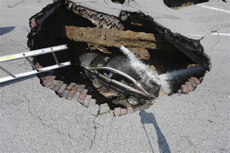 Pamela Knox waits for rescue after a massive sinkhole opened up underneath her car in Toledo, Ohio in this July 3, 2013 handout photo provid Pamela Knox waits for rescue after a massive sinkhole opened up underneath her car in Toledo, Ohio in this July 3, 2013 handout photo provid