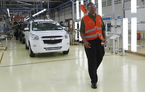 Marcos Purty, president director of General Motors Indonesia, stands next to new Chevrolet Spin MPVs during the official launch of the GM pl Marcos Purty, president director of General Motors Indonesia, stands next to new Chevrolet Spin MPVs during the official launch of the GM pl