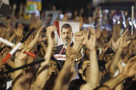Members of the Muslim Brotherhood and supporter of ousted Egyptian President Mohamed Mursi shouts slogans at the Raba El-Adwyia mosque squar Members of the Muslim Brotherhood and supporter of ousted Egyptian President Mohamed Mursi shouts slogans at the Raba El-Adwyia mosque squar