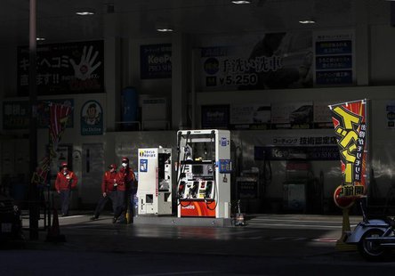 Workers stand to wait for customers at a gas station in Tokyo March 15, 2012. REUTERS/Toru Hanai Workers stand to wait for customers at a gas station in Tokyo March 15, 2012. REUTERS/Toru Hanai