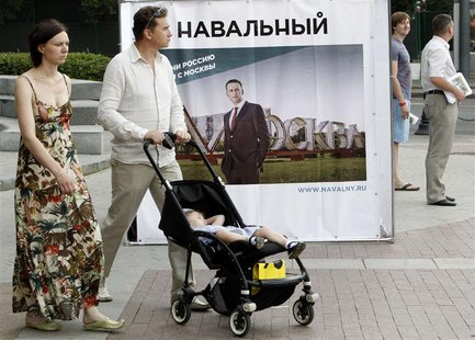 People pass by a banner, part of Russian opposition leader and anti-corruption blogger Alexei Navalny's mayoral election campaign, in Moscow People pass by a banner, part of Russian opposition leader and anti-corruption blogger Alexei Navalny's mayoral election campaign, in Moscow