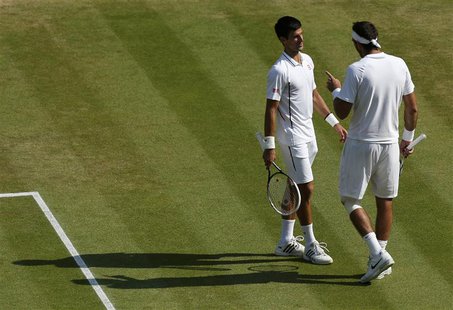 Juan Martin del Potro of Argentina (R) and Novak Djokovic of Serbia speak to each other during their men's semi-final tennis match at the Wi Juan Martin del Potro of Argentina (R) and Novak Djokovic of Serbia speak to each other during their men's semi-final tennis match at the Wi