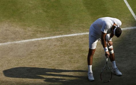 Juan Martin del Potro of Argentina leans on his racquet in his men's semi-final tennis match against Novak Djokovic of Serbia at the Wimbled Juan Martin del Potro of Argentina leans on his racquet in his men's semi-final tennis match against Novak Djokovic of Serbia at the Wimbled