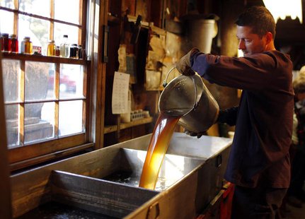Steve Randle pours freshly made maple syrup in the finishing pan at Hollis Hills Farm in Lunenburg, Massachusetts in this February 19, 2012 Steve Randle pours freshly made maple syrup in the finishing pan at Hollis Hills Farm in Lunenburg, Massachusetts in this February 19, 2012