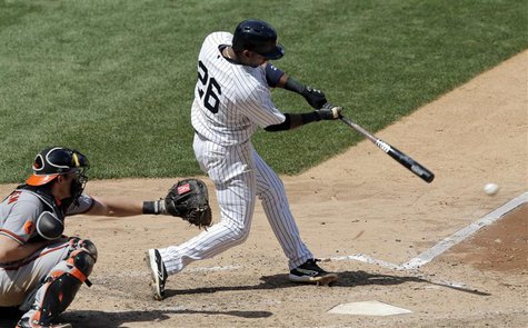 New York Yankees batter Eduardo Nunez hits an RBI single in front of Baltimore Orioles catcher Taylor Teagarden (L) in the sixth inning of t New York Yankees batter Eduardo Nunez hits an RBI single in front of Baltimore Orioles catcher Taylor Teagarden (L) in the sixth inning of t