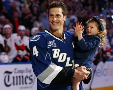Tampa Bay Lightning's Vincent Lecavalier holds his daughter Victoria during a ceremony honoring his 1000th career NHL game before the team's Tampa Bay Lightning's Vincent Lecavalier holds his daughter Victoria during a ceremony honoring his 1000th career NHL game before the team's