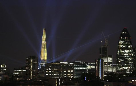 A laser beam touches the Gherkin from the Shard during the laser and searchlight show which marks the completion of the exterior of the Shar A laser beam touches the Gherkin from the Shard during the laser and searchlight show which marks the completion of the exterior of the Shar