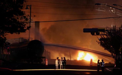 Firefighters look at a train wagon on fire at Lac Megantic, Quebec, July 6, 2013. REUTERS/Mathieu Belanger Firefighters look at a train wagon on fire at Lac Megantic, Quebec, July 6, 2013. REUTERS/Mathieu Belanger