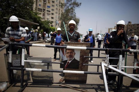 A portrait of deposed Egyptian President Mohamed Mursi is seen at the Raba El-Adwyia mosque square in Cairo July 6, 2013. REUTERS/Khaled Abd A portrait of deposed Egyptian President Mohamed Mursi is seen at the Raba El-Adwyia mosque square in Cairo July 6, 2013. REUTERS/Khaled Abd