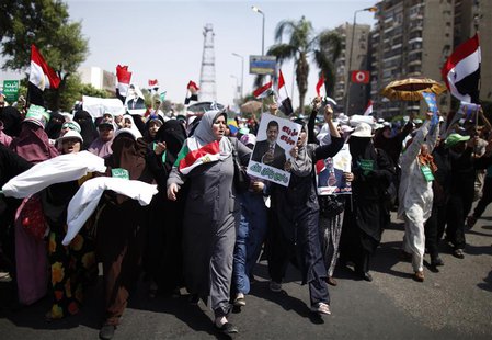 Supporters of deposed Egyptian President Mohamed Mursi march from Raba El-Adwyia square to the Republican Guards headquarters where they bel Supporters of deposed Egyptian President Mohamed Mursi march from Raba El-Adwyia square to the Republican Guards headquarters where they bel